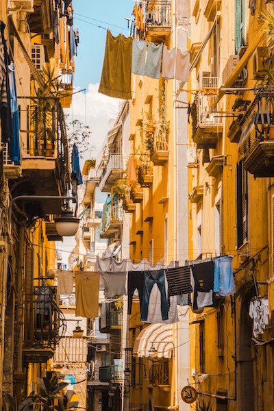 Picture of row apartments in Italy with clothes drying on rope stretched between the apartments over street